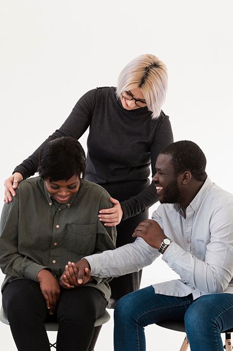 A counselor comforts two clients